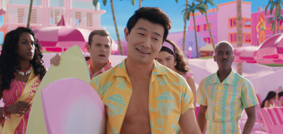 Simu Liu in "Barbie" holding a surf board