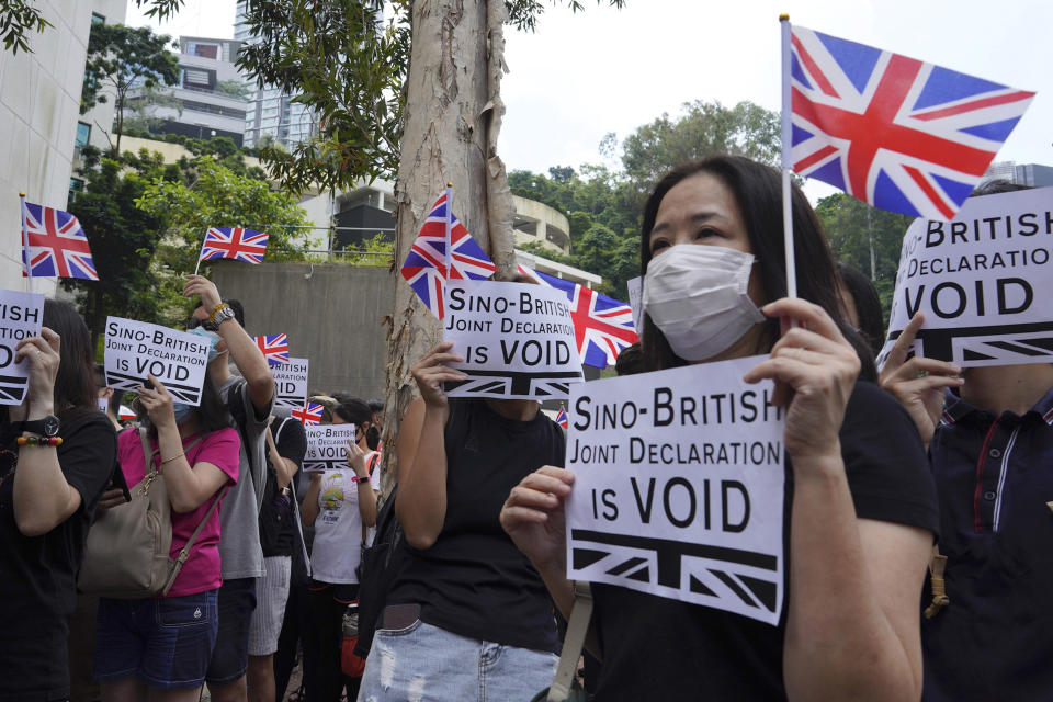 Protesters hold placards and British flags during a peaceful demonstration outside the British Consulate in Hong Kong, Sunday, Sept. 15, 2019. Hundreds of Hong Kong activists rallied outside the Consulate for a second time this month, bolstering calls for international support in their months-long protests for democratic reforms in the semi-autonomous Chinese territory. (AP Photo/Vincent Yu)