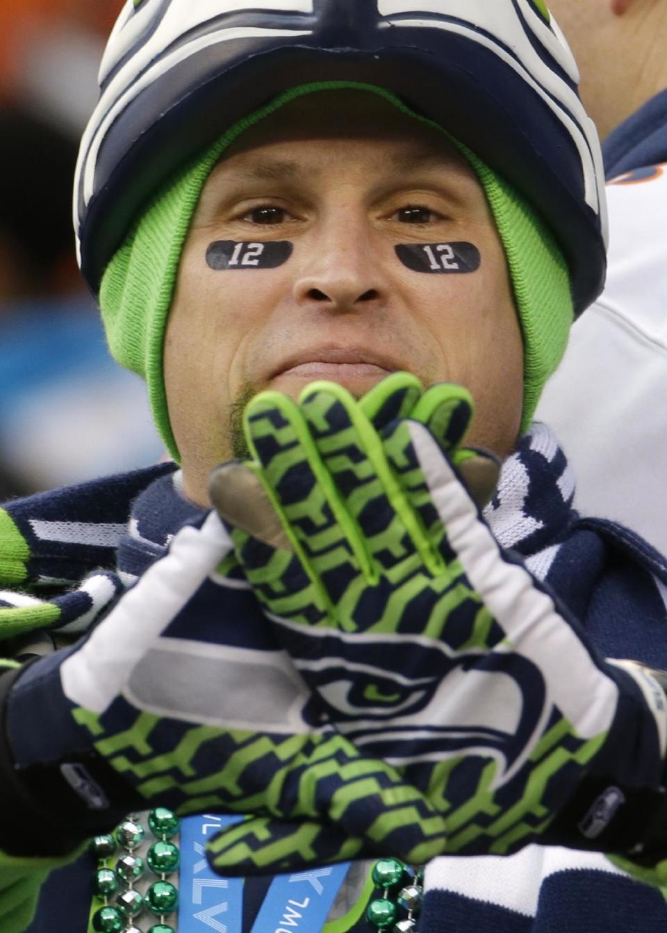 A Seattle Seahawks fan holds his gloved hands up at MetLife Stadium before the NFL Super Bowl XLVIII football game between the Seahawks and the Denver Broncos Sunday, Feb. 2, 2014, in East Rutherford, N.J.(AP Photo/Ted S. Warren)