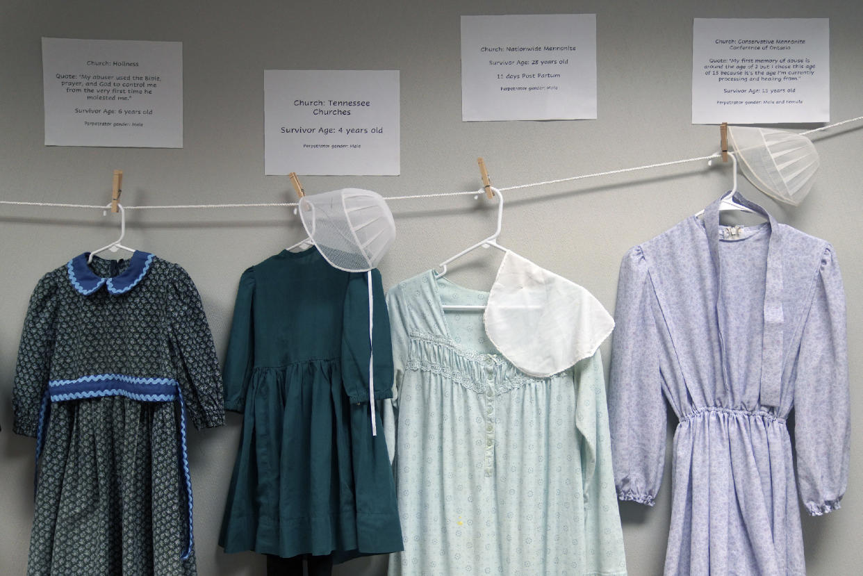 Vestidos donados por víctimas de abusos sexuales en comunidades amish, menonitas y otras, exhibidos durante una conferencia sobre la prevención de abusos llevada a cabo en Leola (Pensilvania) el 29 de abril del 2022. El objetivo de la muestra era demostrar que el uso de prendas recatadas no impide los abusos. (AP Photo/Jessie Wardarski)