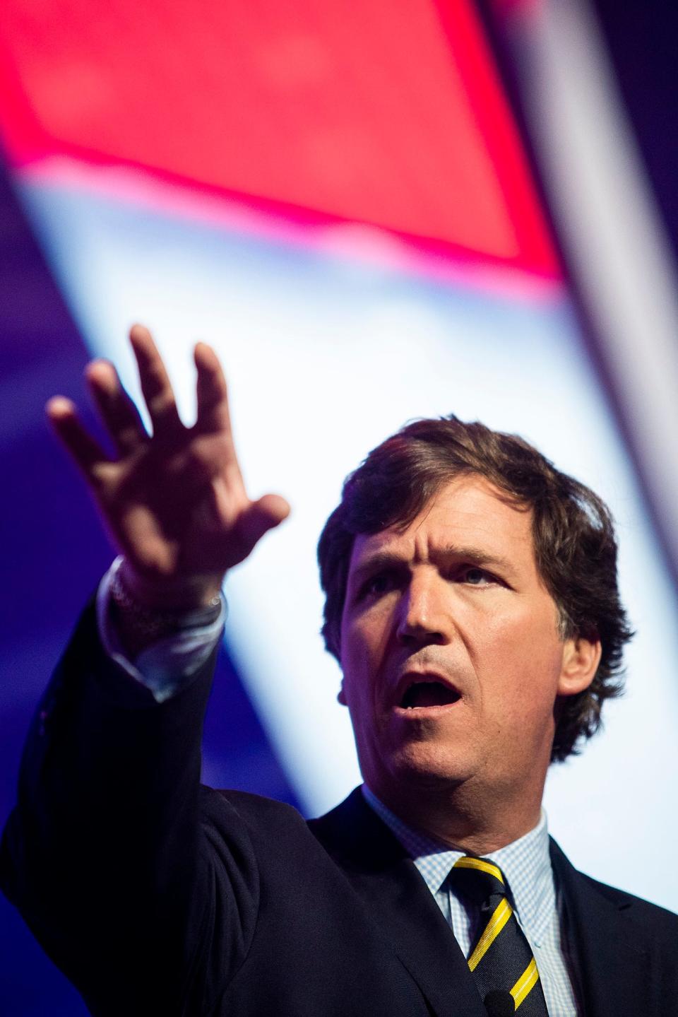 Tucker Carlson speaks during the first day of the America Fest 2021 hosted by Turning Point USA on Saturday, Dec. 18, 2021, in Phoenix. 