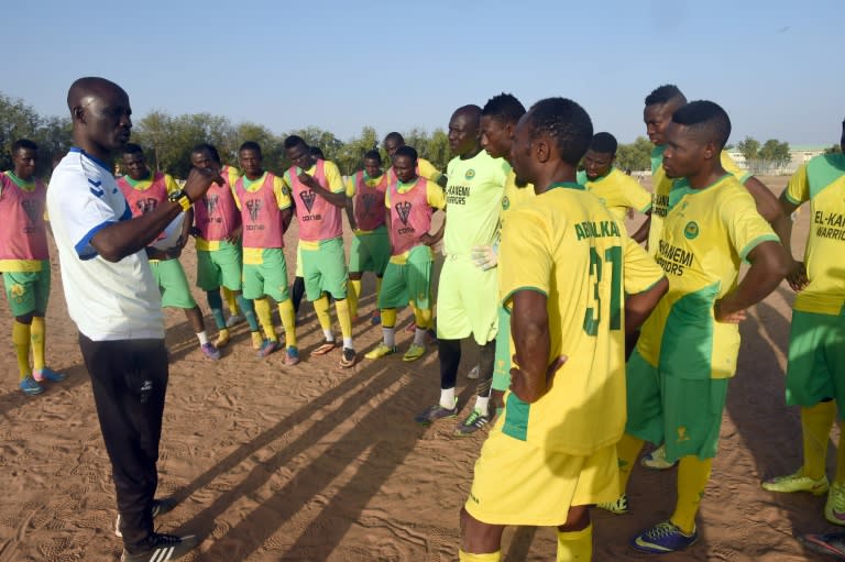 El-Kanemi Warriors coach Ladan Bosso speaks to his players during a training session in Maiduguri on February 2, 2016