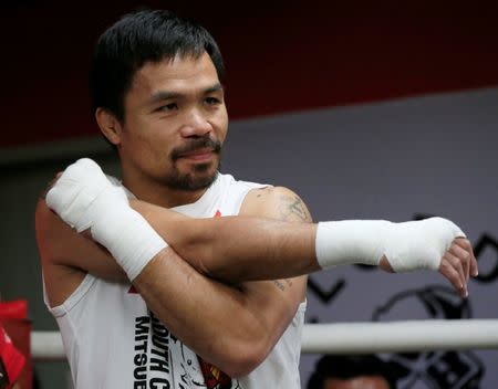 Senator and boxing champion Manny "Pacman" Pacquiao stretches during his training inside the Elorde gym in Pasay city, metro Manila, Philippines September 28, 2016 in preparation for his upcoming bout with Jessie Vargas next month in Las Vegas, U.S.A. REUTERS/Romeo Ranoco