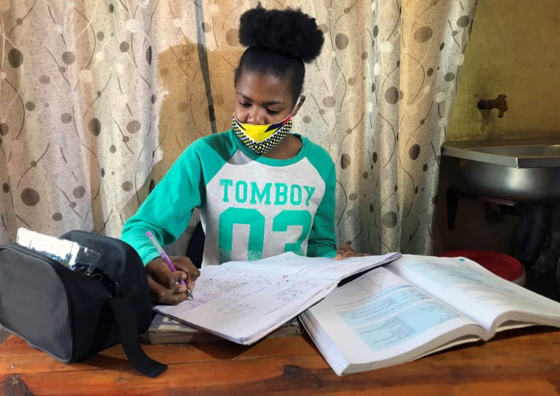 Learner Phuti Ngoetjana tries to study math at her family's one-room brick home during COVID19 outbreak in Tembisa