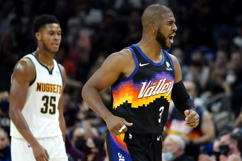 Phoenix Suns guard Chris Paul (3) reacts after a three pointer basket against the Denver Nuggets during the first half of an NBA basketball game, Wednesday, Oct. 20, 2021, in Phoenix. (AP Photo/Matt York)