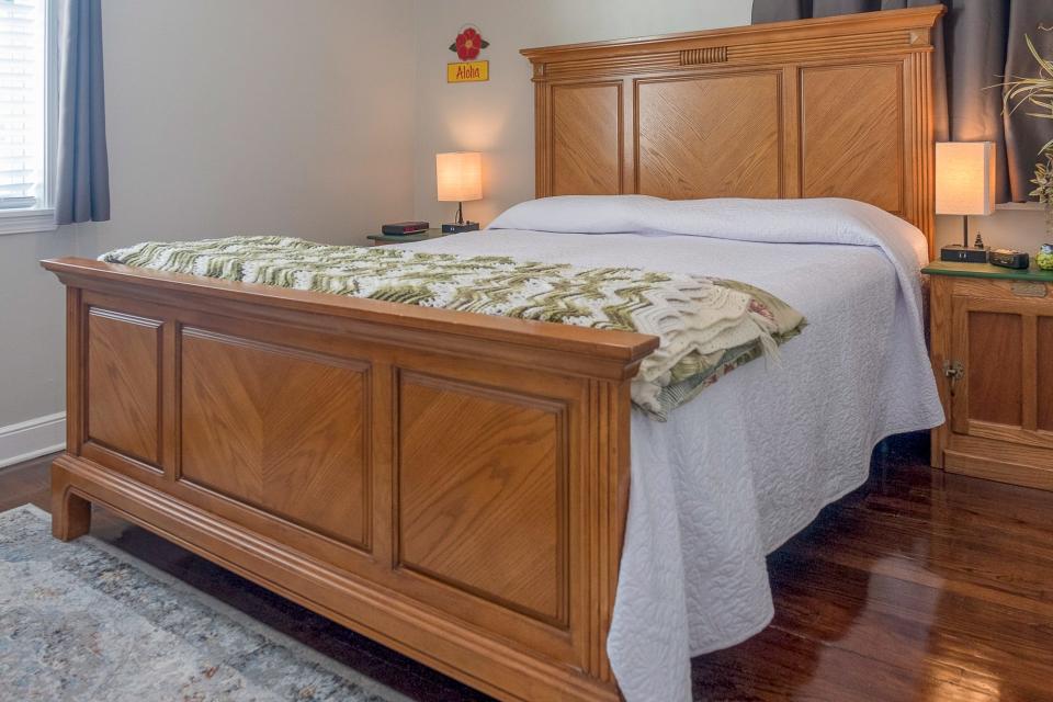 The master bedroom uses various tones of wood to contrast with the original flooring from the early 1950s when the home was built.