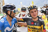 Second placed Spain's Alejandro Valverde, left, congratulates stage winner Sepp Kuss of the US after the fifteenth stage of the Tour de France cycling race over 191.3 kilometers (118.9 miles) with start in Ceret and finish in Andorra-la-Vella, Andorra, Sunday, July 11, 2021. (Thomas Samson/Pool Photo via AP)