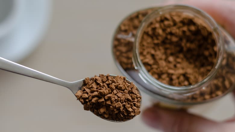 A spoon and jar of instant coffee