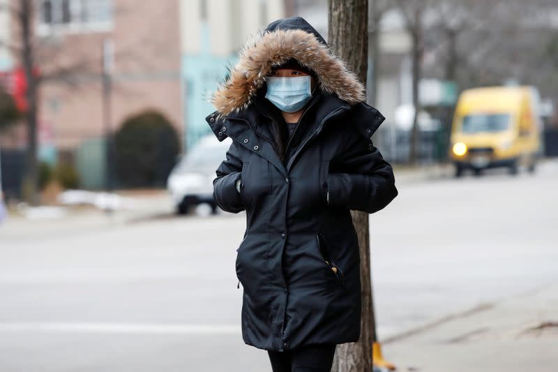 FILE PHOTO: A woman wears a mask following the outbreak of the novel coronavirus, in Chicago