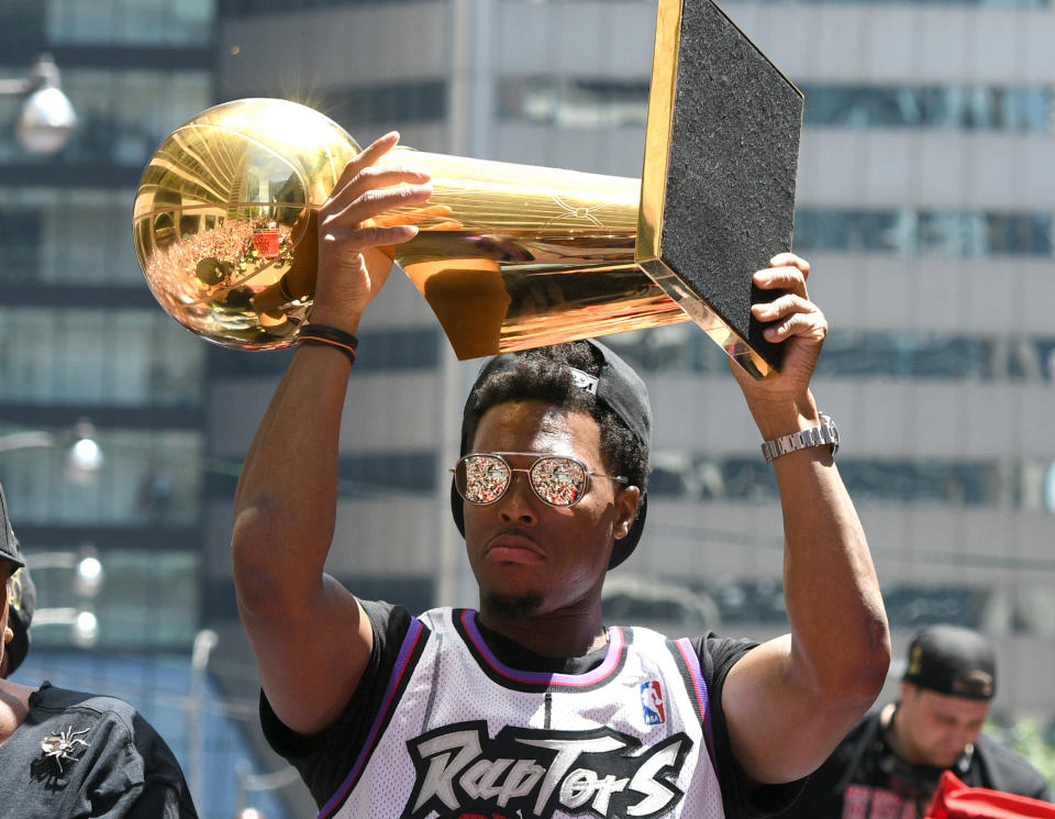 Jun 17, 2019; Toronto, Ontario, Canada;  Toronto Raptors guard Kyle Lowry shows off the Larry O'Brien trophy to fans during a parade through downtown Toronto to celebrate their NBA title. Mandatory Credit: Dan Hamilton-USA TODAY Sports