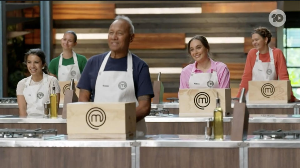 MasterChef contestants in the kitchen with a mystery box