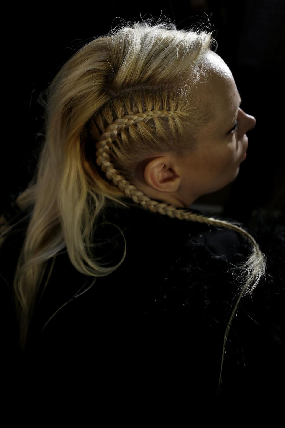 Melissa Burns of New York City has her hair and make-up done backstage before the Fall 2014 DKNY collection is modeled during Fashion Week in New York, Sunday, Feb. 9, 2014. (AP Photo/Seth Wenig)