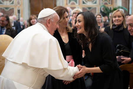 Pope Francis greets people during a meeting with the members of Italian Foreign Press Association at Clementine Hall at the Vatican, May 18, 2019. Vatican Media/­Handout via REUTERS