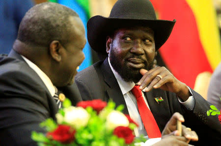 South Sudan's President Salva Kiir (R) talks to South Sudan's rebel leader Riek Machar as they sign a cease fire and power sharing agreement with in Khartoum, Sudan August 5, 2018. REUTERS/Mohamed Nureldin Abdallah