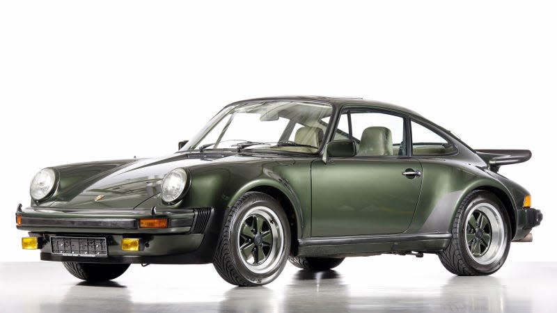 A photo of a green Porsche 911 from the 1970s. 
