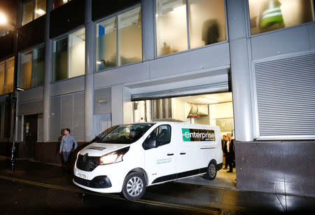 A van and a group of people leave the building which houses the offices of Cambridge Analytica as investigators from Britain's Information Commissioners Office entered, following the granting of a search warrant by a High Court judge, in London, Britain March 23, 2018. REUTERS/Henry Nicholls