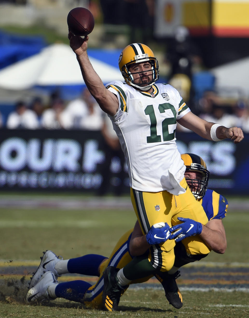 Green Bay Packers quarterback Aaron Rodgers (12) is hauled down by Los Angeles Rams defensive tackle Ethan Westbrooks during the second half of an NFL football game, Sunday, Oct. 28, 2018, in Los Angeles. (AP Photo/Denis Poroy)