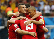 Switzerland's Xherdan Shaqiri (L, face obscured) celebrates his goal with his teammates during their 2014 World Cup Group E soccer match against Honduras at the Amazonia arena in Manaus June 25, 2014. REUTERS/Siphiwe Sibeko (BRAZIL - Tags: SOCCER SPORT WORLD CUP)