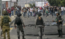 <p>Palestinians clash with Israeli security forces after a protest marking Nakba, or “catastrophe”, commemorating the more than 700,000 Palestinians who fled or were expelled in the 1948 war surrounding Israel’s creation, and against the US’ relocation of its embassy from Tel Aviv to Jerusalem, at the Hawara checkpoint south of Nablus on May 15, 2018. (Photo: Jaafar Ashtiyeh/ AFP/Getty Images) </p>