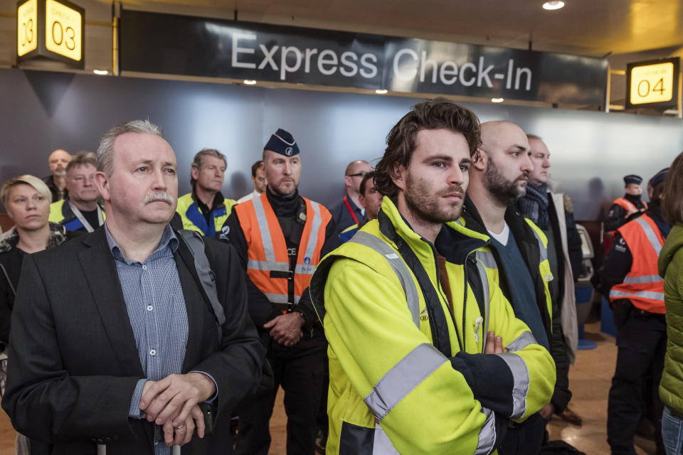 People observe a minute of silence near a memorial during a one-year anniversary service at Zaventem Airport in Brussels on Wednesday, March 22, 2017. The suicide bombings at the Brussels airport and subway on March 22, 2016, killed 32 people and wounded more than 300 others. (AP Photo/Geert Vanden Wijngaert)