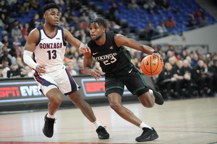 Portland State guard Jorell Saterfield (23) drives as Gonzaga guard Malachi Smith (13) defends during the first half of an NCAA college basketball game in the Phil Knight Legacy tournament Thursday, Nov. 24, 2022, in Portland, Ore. (AP Photo/Rick Bowmer)