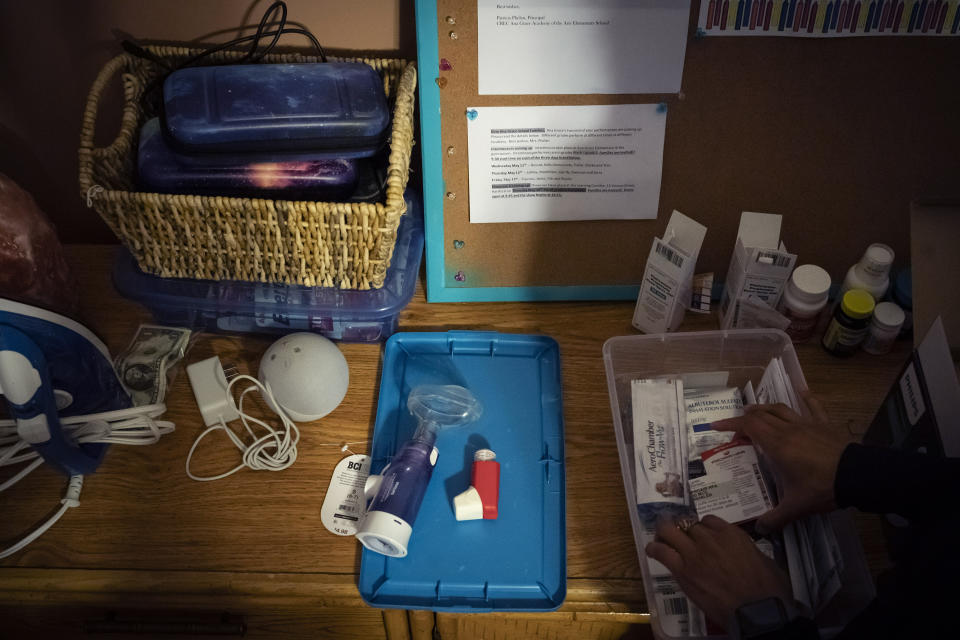 Catherine Manson sorts through asthma medication for her children in Hartford, Conn., on Wednesday, May 25, 2022. A 2019 analysis highlighted by the Asthma and Allergy Foundation found that exposure to pollutants - specifically, fine particulate matter - was disproportionately experienced by Black and Hispanic populations, while the emissions were disproportionately caused by white populations. (AP Photo/Wong Maye-E)