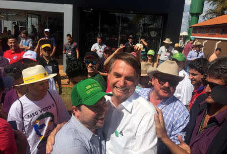 Federal deputy Jair Bolsonaro, a pre-candidate for Brazil's presidential elections, is greeted by supporters in Ribeirao Preto, Sao Paulo state, Brazil April 30, 2018. Picture taken April 30, 2018. REUTERS/Marcelo Texeira