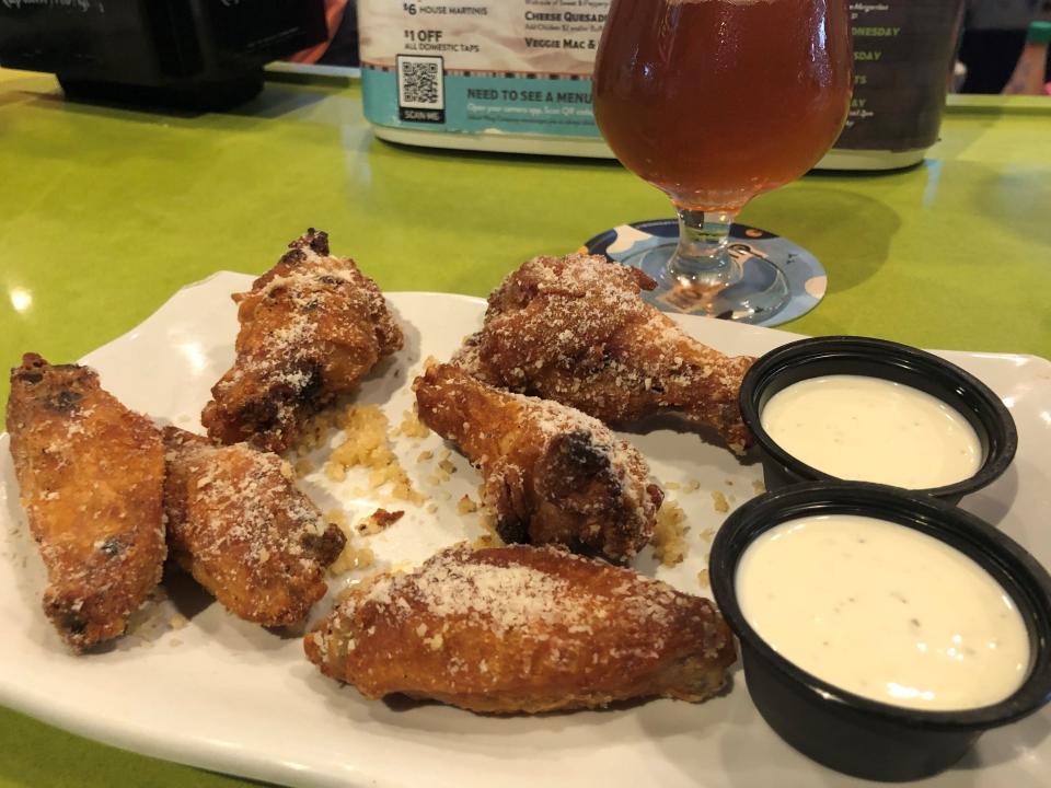 Like all their wings, Island Wing Company's Garlic Parmesan wings are baked, shown here with Bleu Cheese dipping sauce.