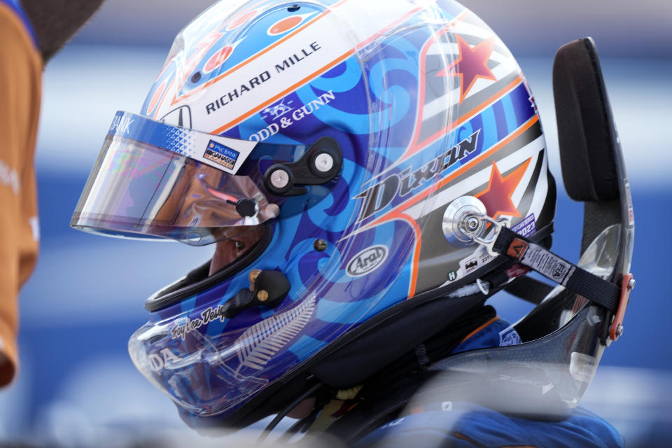 Scott Dixon, of New Zealand, gets into his car during practice for an IndyCar Series auto race, Friday, July 21, 2023, at Iowa Speedway in Newton, Iowa. (AP Photo/Charlie Neibergall)