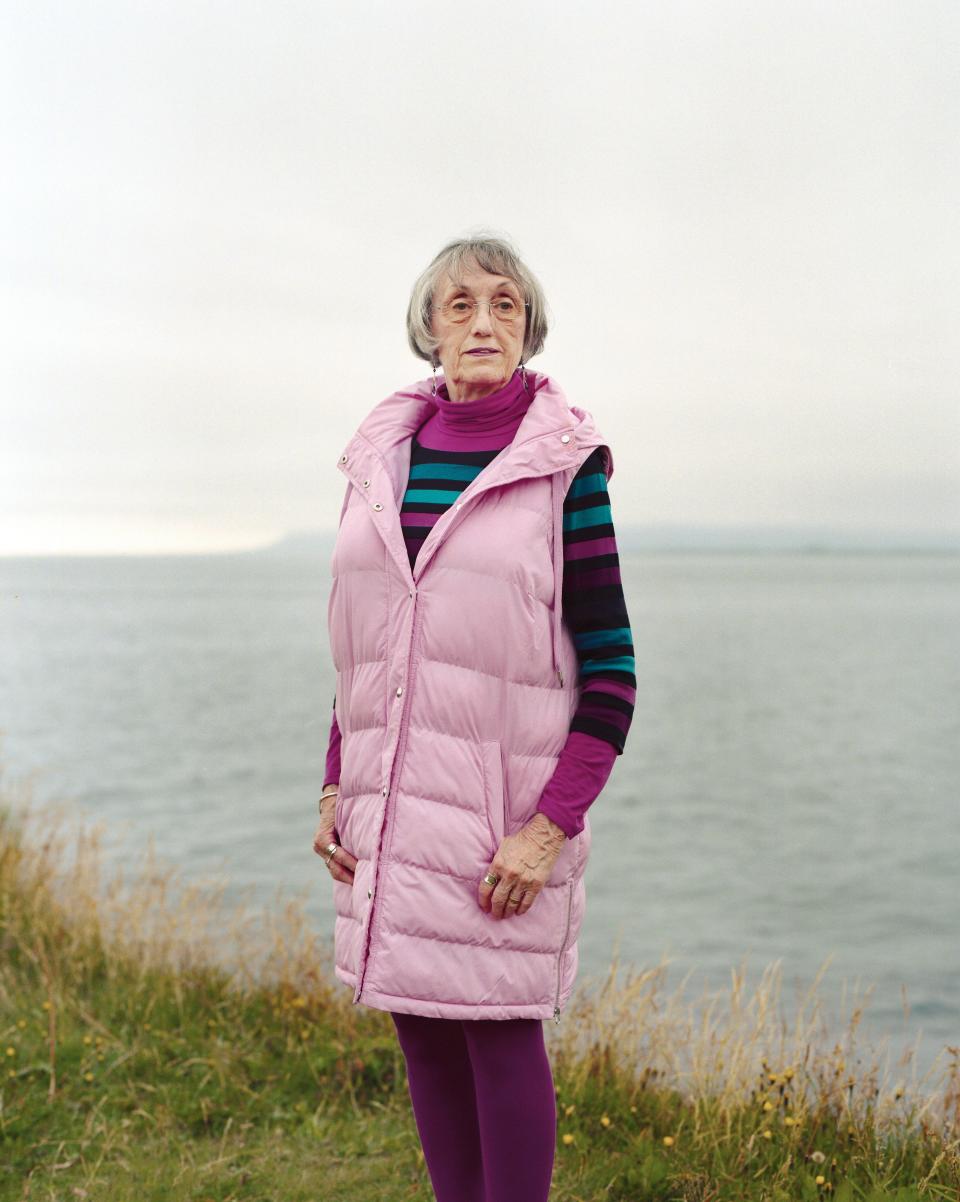 Woman standing against Icelandic landscape.
