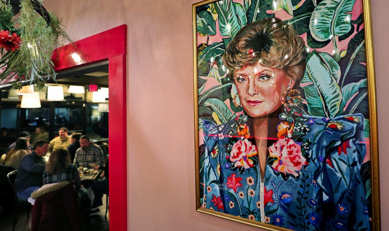Prints of the The Golden Girls, including Blanche, keep a watchful eye over guests as they dine during the soft opening of the new Square Scullery restaurant, Monday, Jan. 29, 2024, in Akron, Ohio.