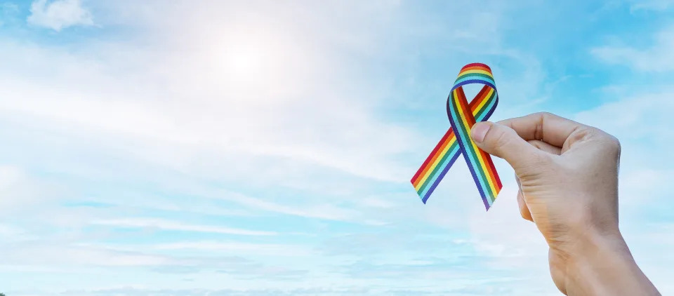 LGBTQ Rainbow ribbon against sky, symbolising the celebration of Pride Month