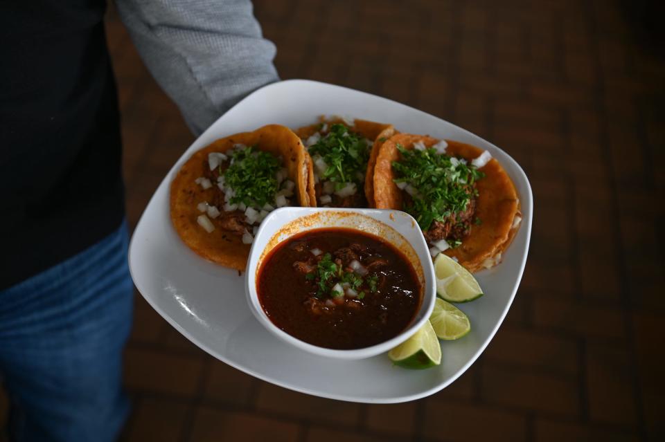 El Molino Mexican Restaurant owner Joaquin Santos shows a plate of freshly prepared , plate of birria tacos, Tuesday, Nov. 28, 2023, at his new Mexican restaurant inside The Windmill Travel Center & Truckstop on Lansing Road in Dimondale.