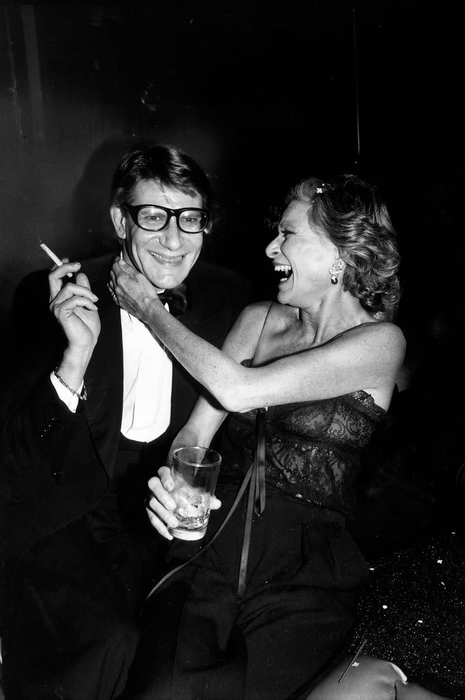 <p>Yves Saint Laurent with socialite Nan Kempner during a party for the launch of his new perfume called Opium, held aboard the sailboat Peking at the South Street Seaport Museum in New York in 1978.</p>