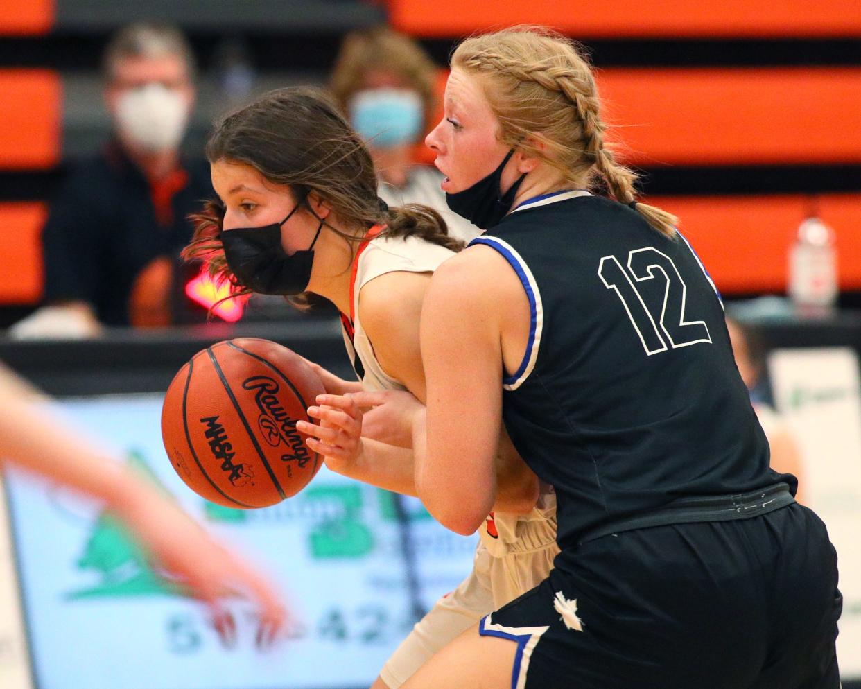 Tecumseh sophomore Chesney Wilke drives with the ball against an Adrian defender during the Division 2 district contest between the teams on March 22.