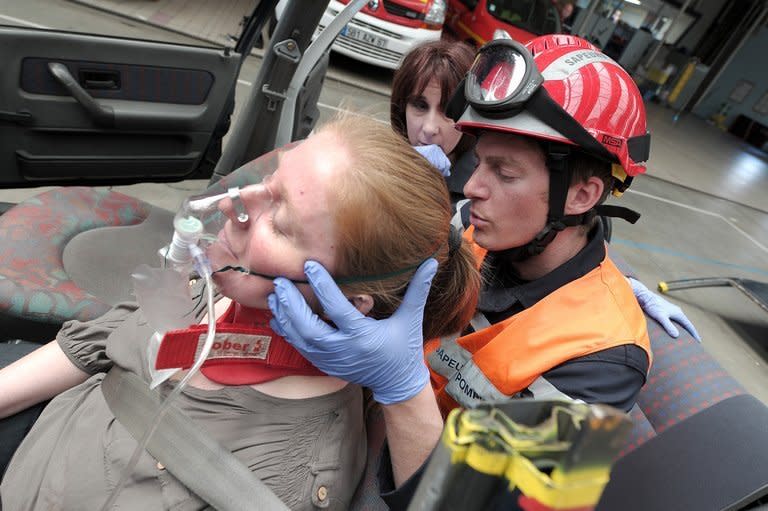 A fireman keeps a person under hypnosis during an extrication exercise in Haguenau, France on May 28, 2013. At the Haguenau fire station, 120 firemen have been trained in basic medical hypnosis which they can use to soothe someone trapped in a car following an accident