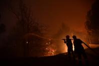 Firefighters try to extinguish a wildfire in Afidnes area, northern Athens, Greece, Thursday, Aug. 5, 2021. Wildfires rekindled outside Athens and forced more evacuations around southern Greece Thursday as weather conditions worsened and firefighters in a round-the-clock battle stopped the flames just outside the birthplace of the ancient Olympics. (AP Photo/Michael Varaklas)