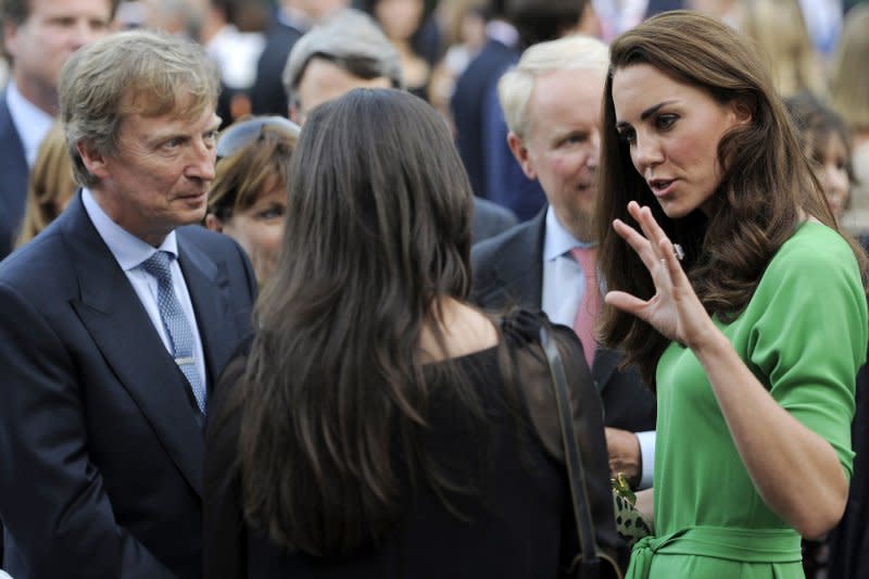 Kate, the Duchess of Cambridge, mingles with guests including television producer Nigel Lythgoe, far left, during a private reception at the British Consul-General's residence in Los Angeles in 2011. File Photo by Chris Pizzello/pool
