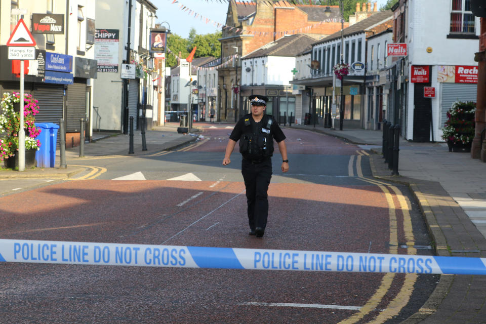 An officer at the scene in Westhoughton. (SWNS)