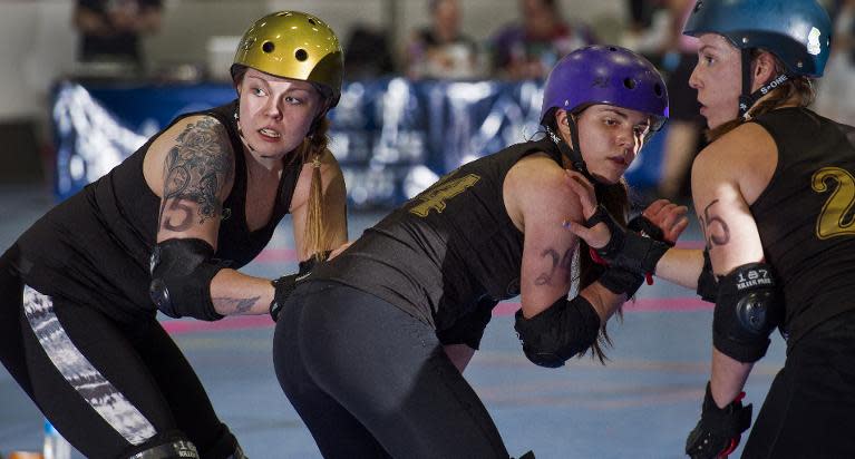 Members of the Rideau Valley Vixens from Ottawa, Canada, prepare to block DC Rollergirls on April 5, 2014 during the womens's flat track Roller Derby at the Dulles Sportsplex in Sterling, Virginia