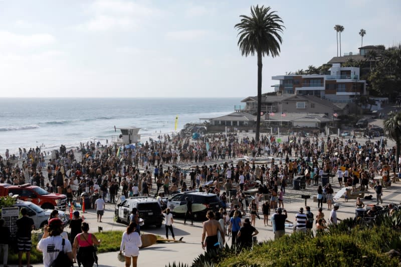 People and surfers gather at Moonlight Beach in Encinitas, California, for the "Paddle out for Unity" event in support of Black Lives Matter, following the death of George Floyd