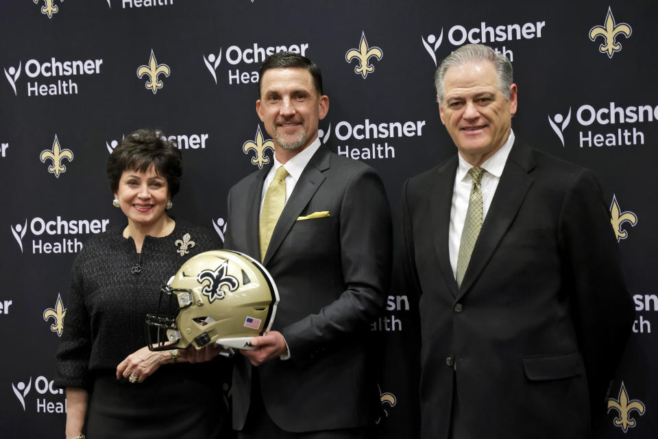 New Orleans Saints new head coach Dennis Allen, center, poses for a picture with team owner Gayle Benson, left and general manager Mickey Loomis following a news conference at the NFL football team's training facility, Tuesday, Feb. 8, 2022, in Metairie, La. (AP Photo/Derick Hingle)