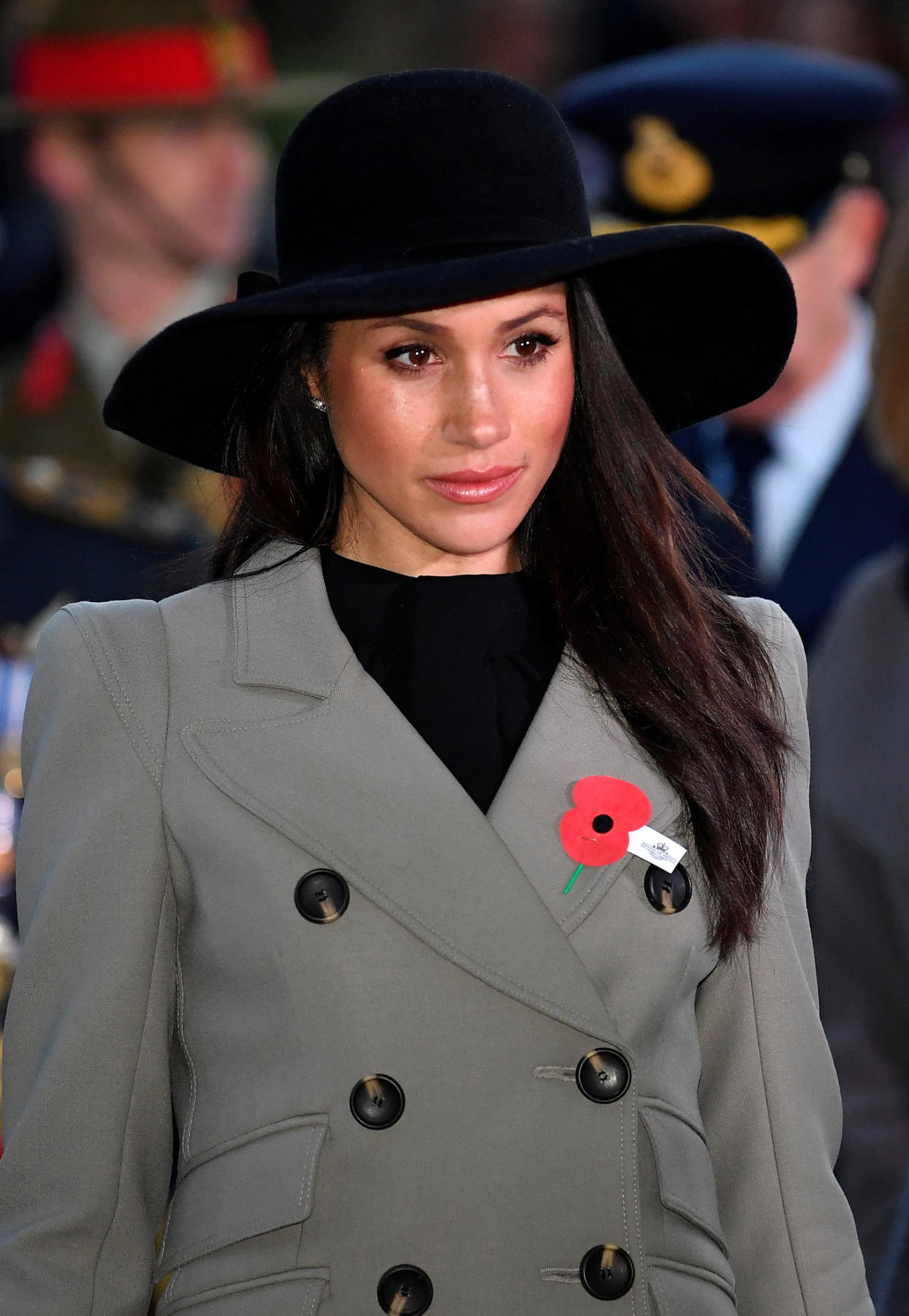 Markle paid her respects with somber style and a poppy pin. (Photo: Toby Melville/AFP/Getty Images)