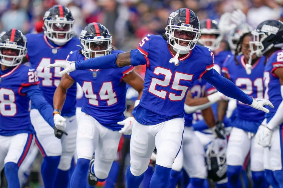 New York Giants cornerback Deonte Banks (25) celebrates with teammates after catching an interception during an NFL football game against the Washington Commanders, Sunday Oct. 22, 2023, in East Rutherford, N.J. (AP Photo/Bryan Woolston)