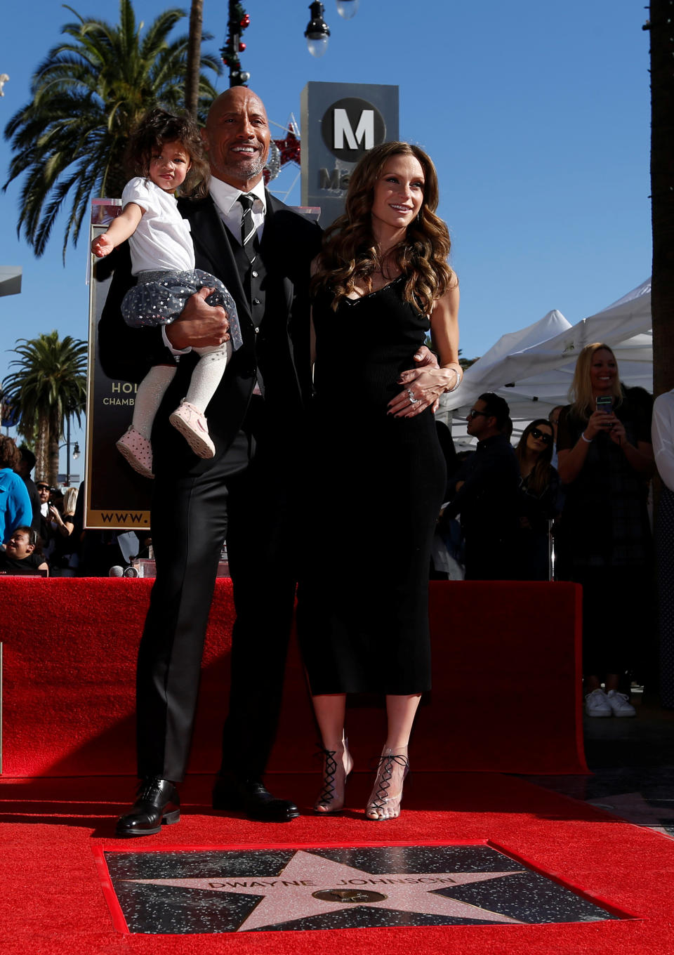 Actor Dwayne Johnson poses on his star with Lauren Hashian and their daughter Jasmine Lia after it was unveiled on the Hollywood Walk of Fame in Los Angeles, California, U.S., December 13, 2017.
