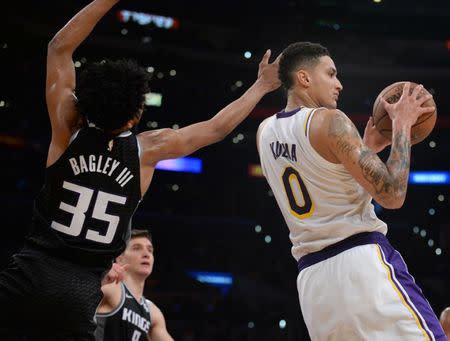 March 24, 2019; Los Angeles, CA, USA; /Los Angeles Lakers forward Kyle Kuzma (0) grabs an offensive rebound against Sacramento Kings forward Marvin Bagley III (35) during the second half at Staples Center. Mandatory Credit: Gary A. Vasquez-USA TODAY Sports