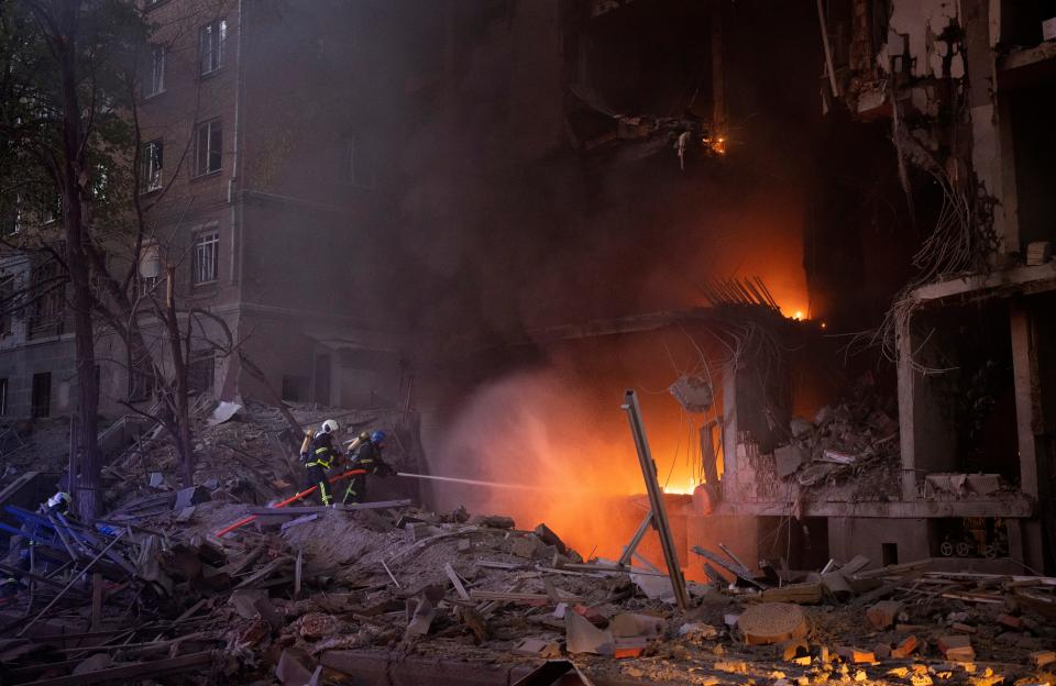 Firefighters try to put out a fire following an explosion in Kyiv, Ukraine on Thursday, April 28, 2022. Russia mounted attacks across a wide area of Ukraine on Thursday, bombarding Kyiv during a visit by the head of the United Nations. (AP Photo/Emilio Morenatti) ORG XMIT: EM127