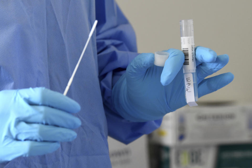 University of Miami Miller School of Medicine nurse Loreta Padron prepares to test a volunteer for COVID-19, Wednesday, Sept. 2, 2020 in Miami. Miami is one of 89 cities around the U.S. that's testing the Moderna COVID-19 vaccine. (AP Photo/Taimy Alvarez)