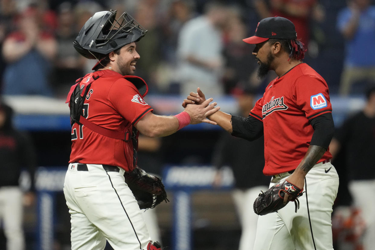 Cleveland Guardians catcher Austin Hedges, left, and relief pitcher Emmanuel Clase, right, celebrate after they defeated the Minnesota Twins in a baseball game Monday, Sept. 16, 2024, in Cleveland. (AP Photo/Sue Ogrocki)