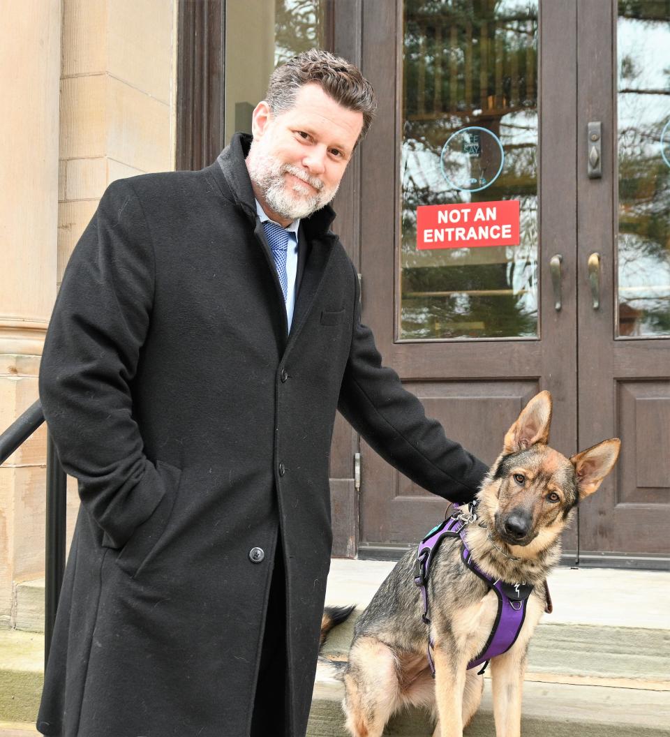 St. Joseph County prosecutor David Marvin and his service dog Greta on the steps of the county courthouse.